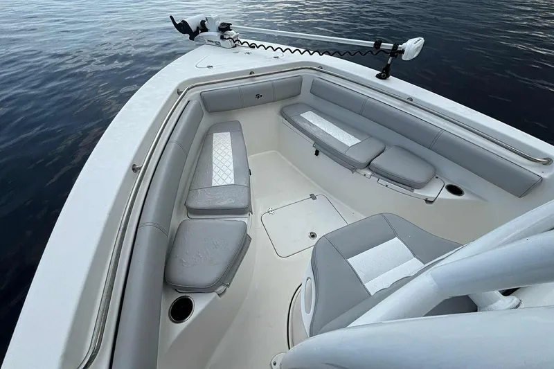 Slide: The Image of 2020 Sea Pro 219 Center Console boat interior with cushioned seating and trolling motor. - 21