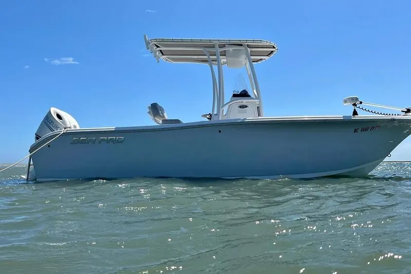 Slide: The Image of 2020 Sea Pro 219 Center Console boat on water under clear blue sky. - 27