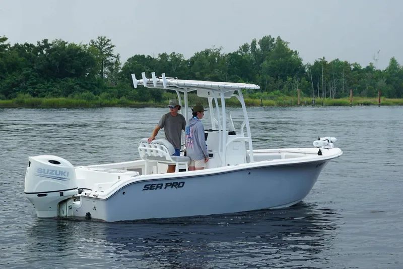 Slide: The Image of 2020 Sea Pro 219 Center Console boat on calm water with two people onboard. - 3