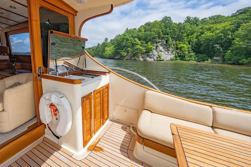 Slide: The Image of Luxurious 2007 Vicem 65 yacht interior with scenic river view and lush greenery. - 11