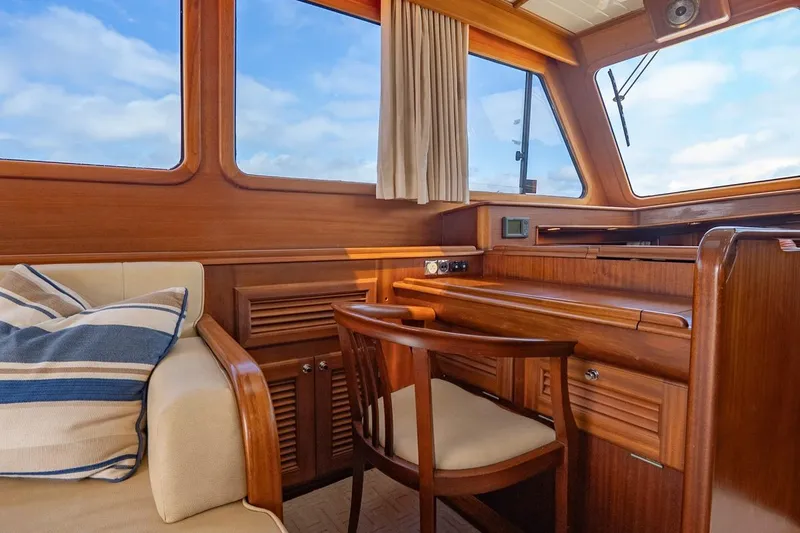 Slide: The Image of Interior of 2007 Vicem 65 yacht with wooden desk and seating, featuring large windows. - 15