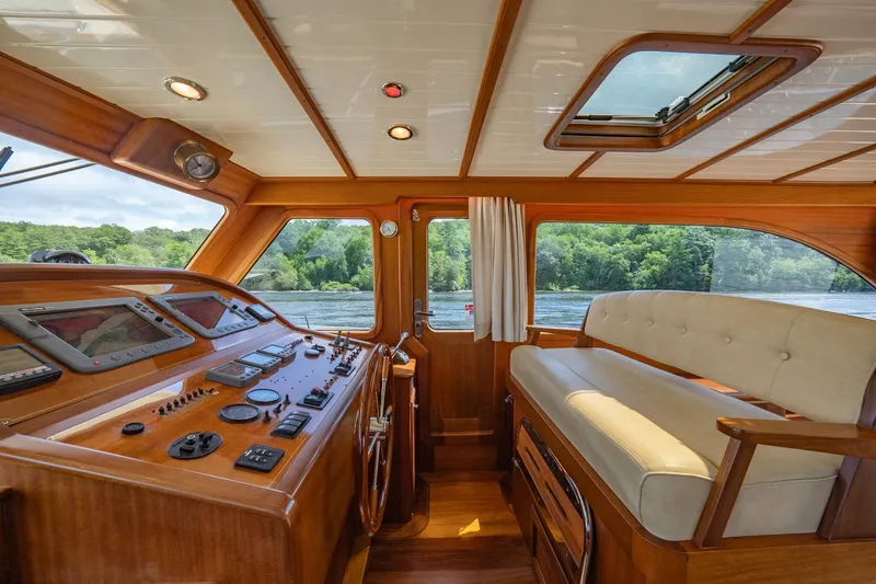 Slide: The Image of Luxurious 2007 Vicem 65 yacht interior with wooden helm and plush seating. - 17
