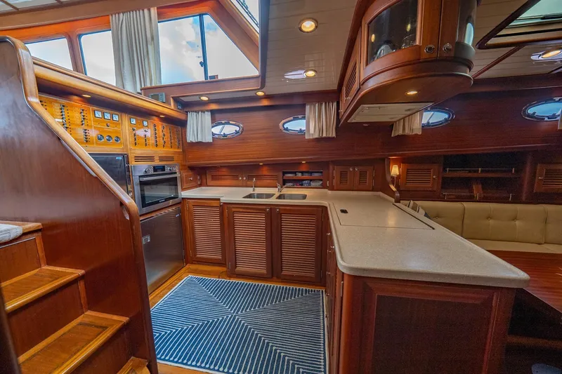 Slide: The Image of Luxurious 2007 Vicem 65 yacht interior with wooden cabinetry and modern kitchen amenities. - 18