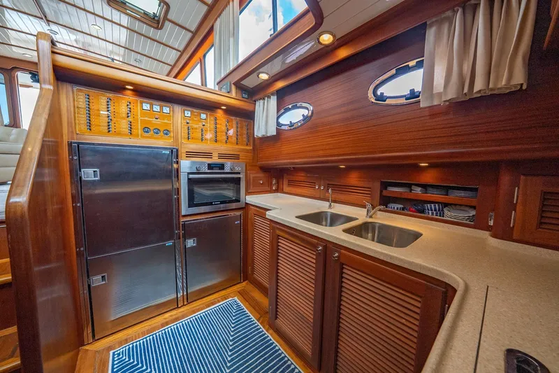 Slide: The Image of Luxurious 2007 Vicem 65 yacht kitchen with wood cabinetry and stainless steel appliances. - 19