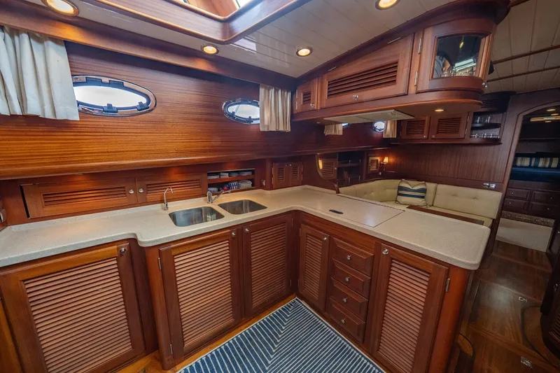 Slide: The Image of Luxurious 2007 Vicem 65 yacht interior with elegant wood cabinetry and modern kitchen amenities. - 20