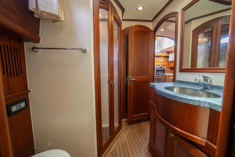 Slide: The Image of Luxurious 2007 Vicem 65 yacht bathroom with wooden cabinetry and modern fixtures. - 25