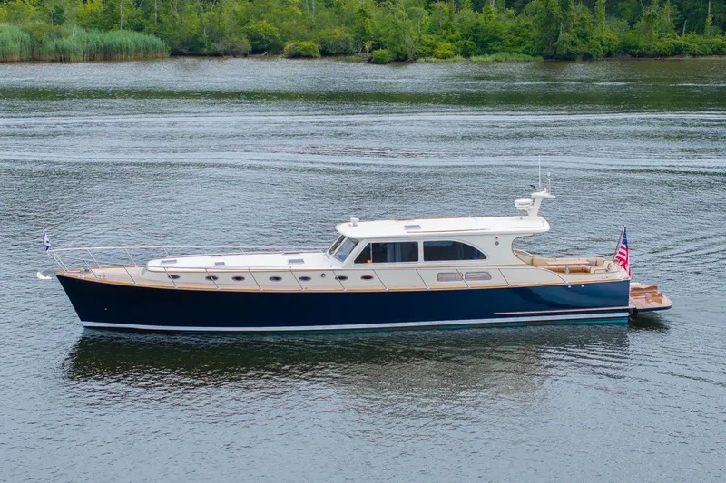 Slide: The Image of 2007 Vicem 65 yacht on calm water with lush green shoreline. - 33