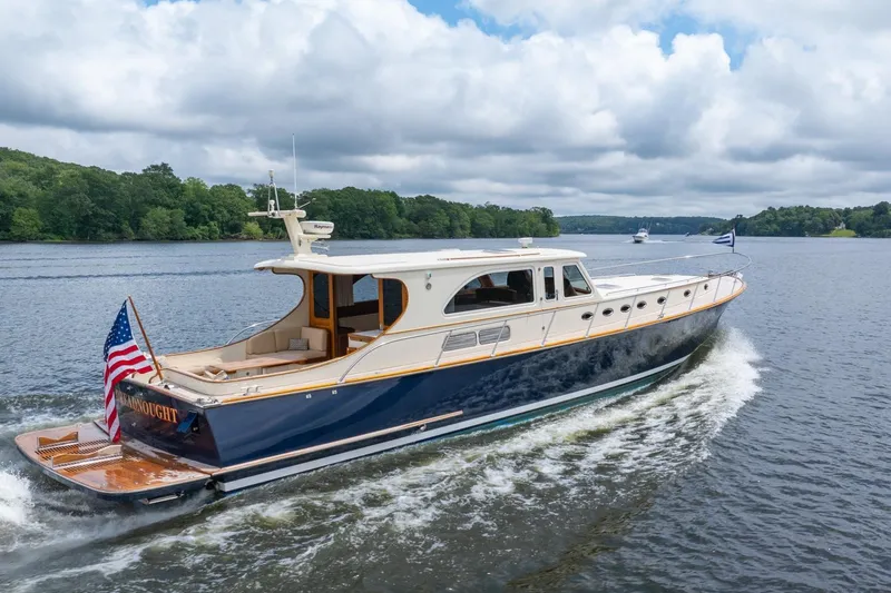 Slide: The Image of 2007 Vicem 65 yacht cruising on a scenic river under cloudy skies. - 34