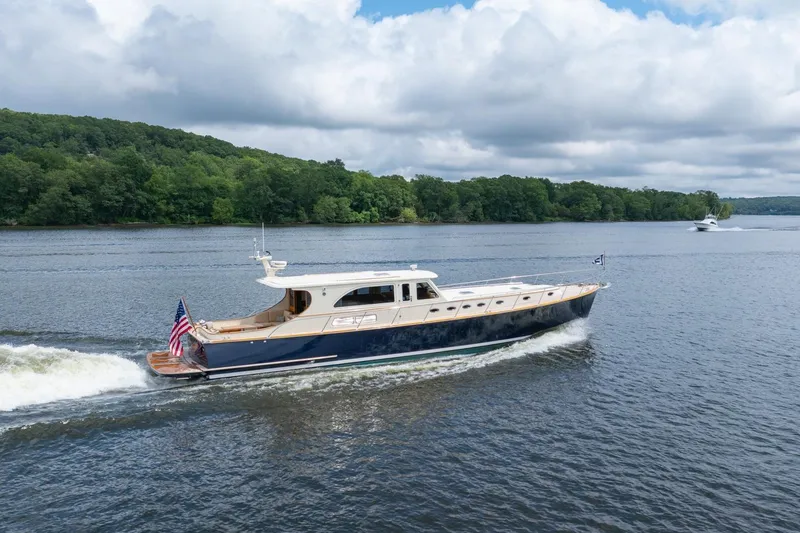 Slide: The Image of 2007 Vicem 65 yacht cruising on a scenic river with lush green forest backdrop. - 35