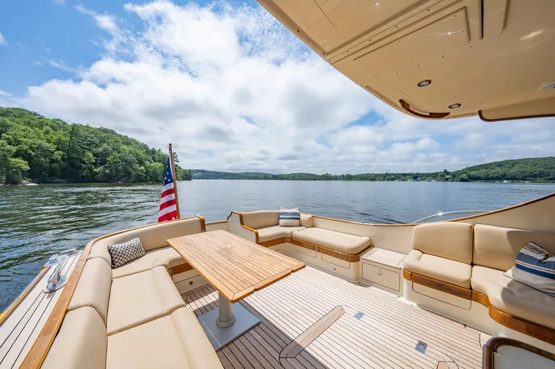 Slide: The Image of Luxurious 2007 Vicem 65 yacht deck with seating, table, and scenic lake view. - 37