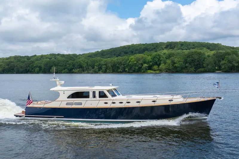 Slide: The Image of 2007 Vicem 65 yacht cruising on a scenic river with lush green forest backdrop. - 38