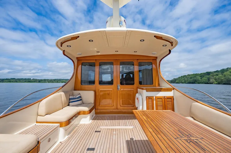 Slide: The Image of Luxurious 2007 Vicem 65 yacht deck with elegant wood finish and comfortable seating. - 9
