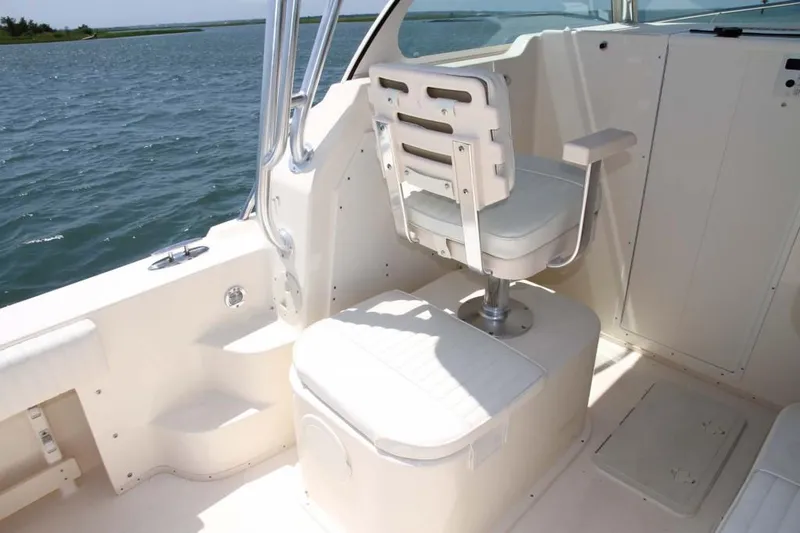 Slide: The Image of Manufacturer Provided Image: 2015 Parker 2510 XLD Walkaround boat interior with captain's chair and ocean view. - 16