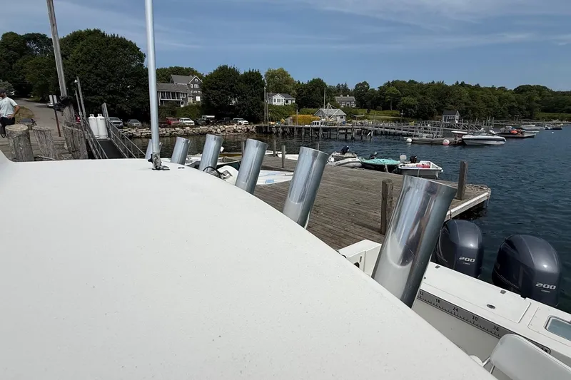 Slide: The Image of 2015 Parker 2510 XLD Walkaround docked at scenic waterfront with boats and houses. - 22