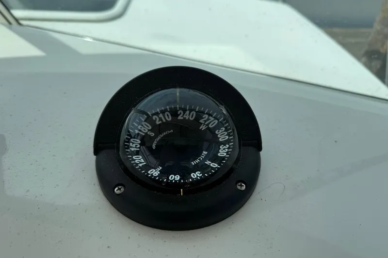 Slide: The Image of Compass on 2015 Parker 2510 XLD Walkaround boat dashboard, showing navigation directions. - 24