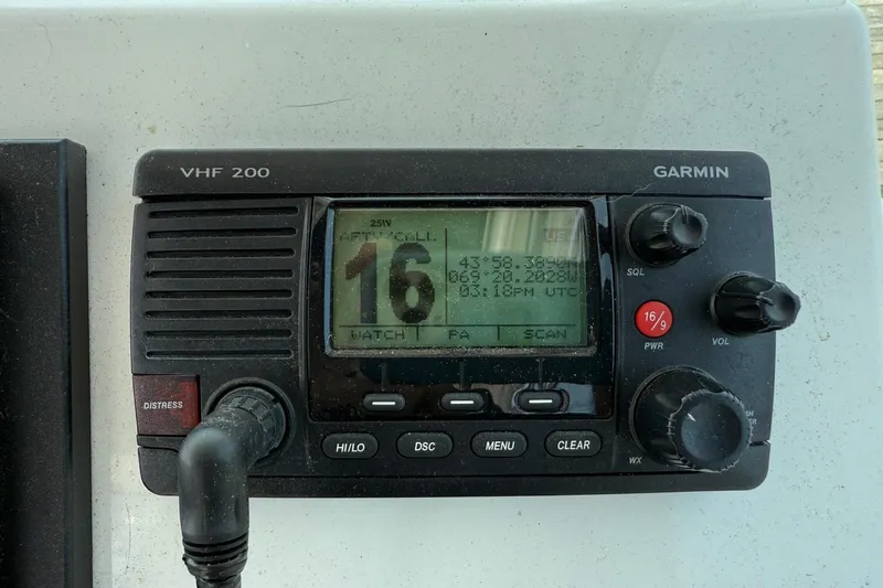 Slide: The Image of Garmin VHF 200 radio on 2015 Parker 2510 XLD Walkaround boat dashboard. - 26