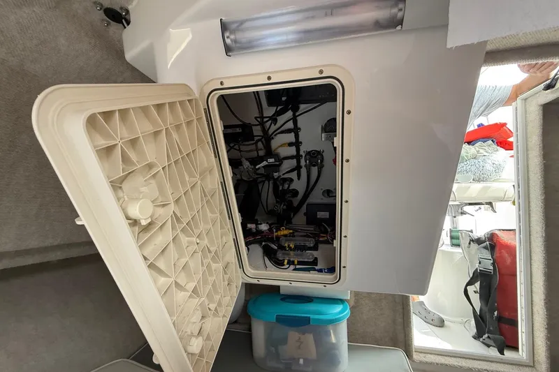 Slide: The Image of 2015 Parker 2510 XLD Walkaround interior showing open electrical panel and storage area. - 34