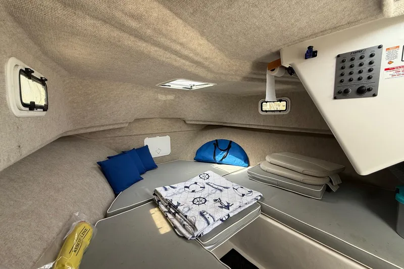 Slide: The Image of 2015 Parker 2510 XLD Walkaround cabin interior with cushions and nautical-themed blanket. - 36