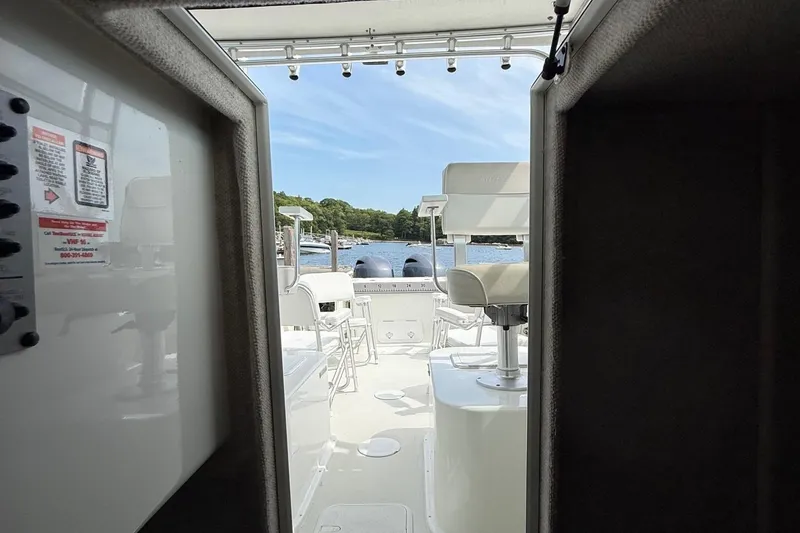 Slide: The Image of 2015 Parker 2510 XLD Walkaround boat interior with view of water and seating. - 37