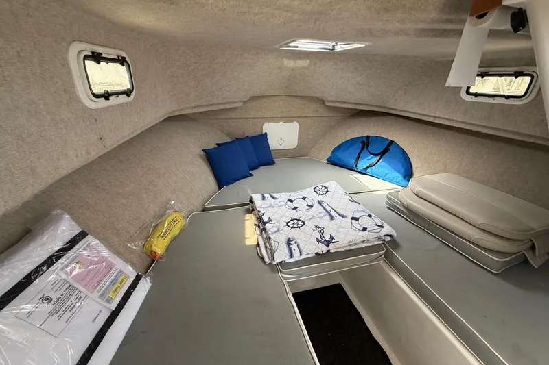 Slide: The Image of 2015 Parker 2510 XLD Walkaround cabin interior with cushions and nautical-themed bedding. - 40