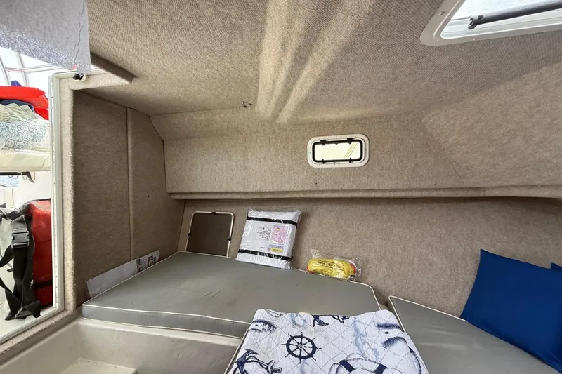 Slide: The Image of 2015 Parker 2510 XLD Walkaround cabin interior with cushions and nautical decor. - 41
