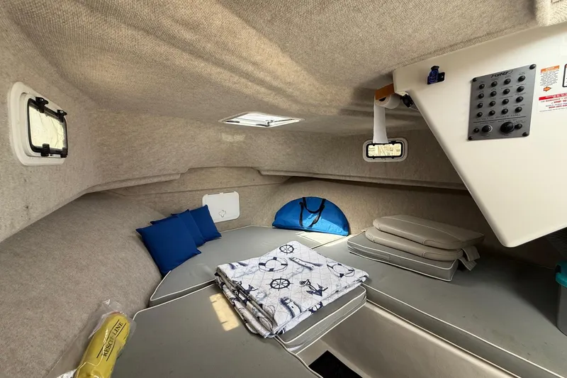 Slide: The Image of 2015 Parker 2510 XLD Walkaround cabin interior with cushions and nautical-themed blanket. - 42