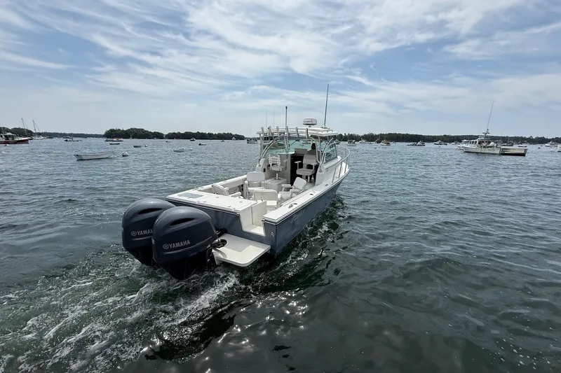 Slide: The Image of 2015 Parker 2510 XLD Walkaround boat with twin Yamaha engines on open water. - 7