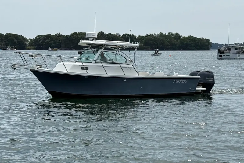 Slide: The Image of 2015 Parker 2510 XLD Walkaround boat on calm water, side view. - 8