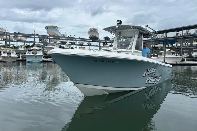 The Image of 2006 Sailfish 2660 CC boat docked in marina, overcast sky, "Cool Profits" on side. - 0