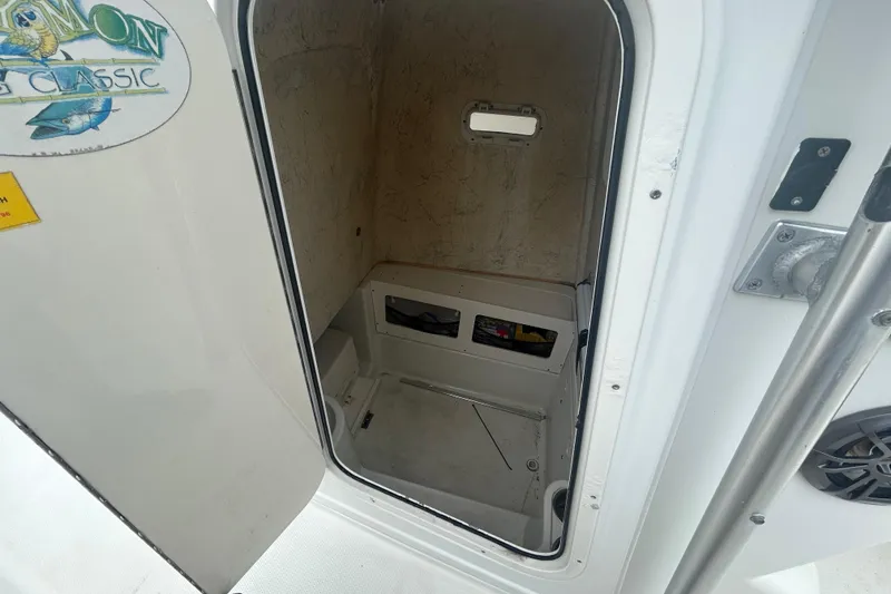 Slide: The Image of 2006 Sailfish 2660 CC boat interior cabin with open door and storage space. - 10