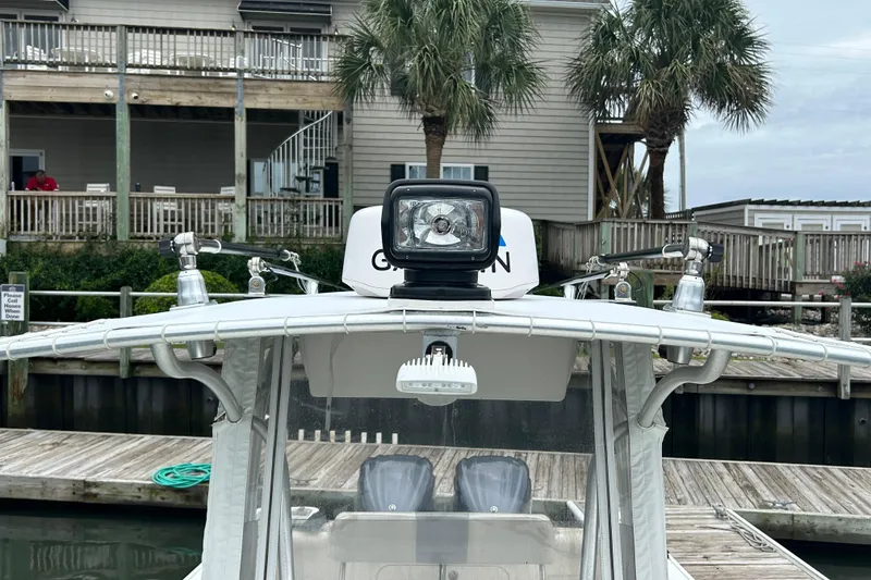 Slide: The Image of 2006 Sailfish 2660 CC boat docked with spotlight and palm trees in background. - 13