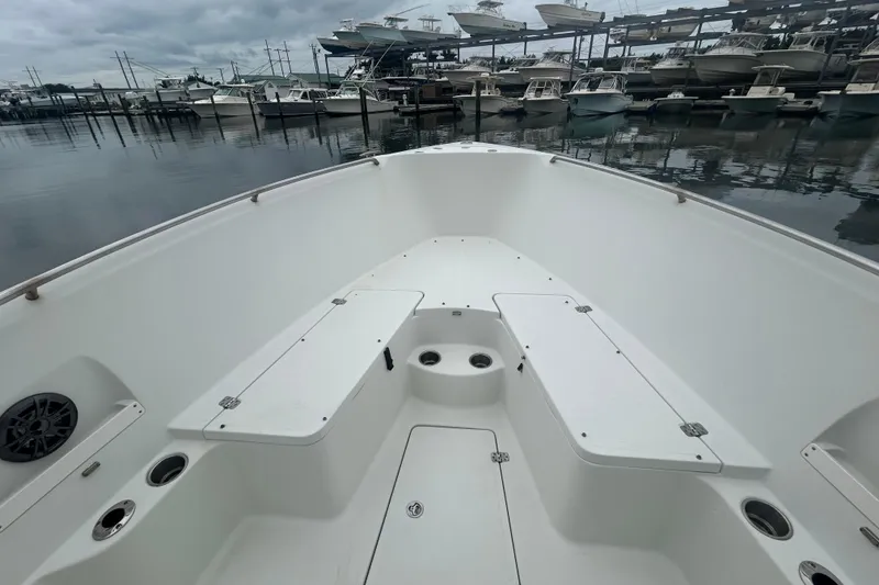 Slide: The Image of 2006 Sailfish 2660 CC boat interior with seating, cup holders, and marina view. - 17