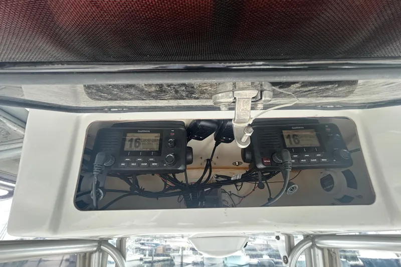 Slide: The Image of 2006 Sailfish 2660 CC boat electronics, featuring Garmin marine radios and wiring. - 21