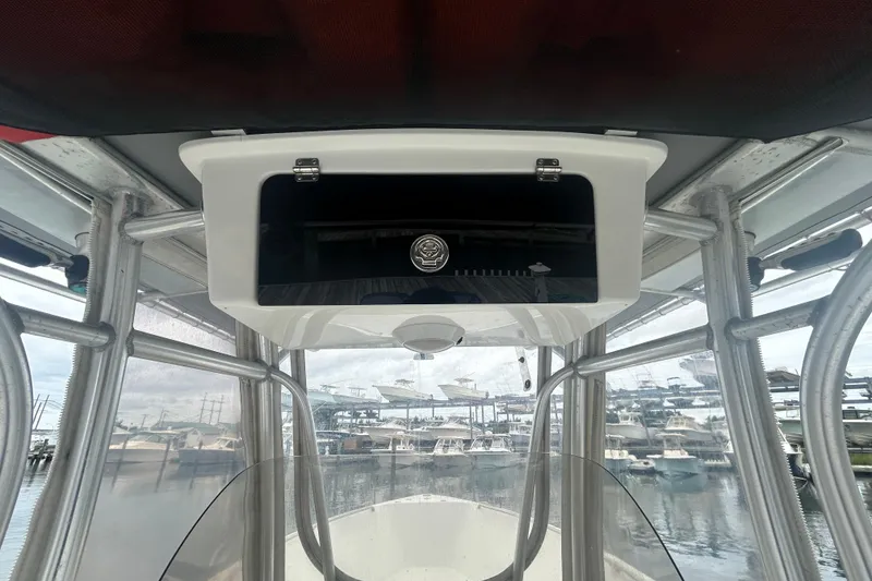 Slide: The Image of 2006 Sailfish 2660 CC boat console with storage compartment, docked at marina. - 22