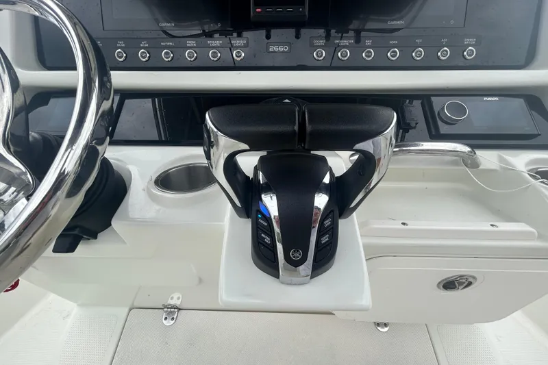Slide: The Image of Control panel of a 2006 Sailfish 2660 CC boat with steering wheel and throttle. - 23