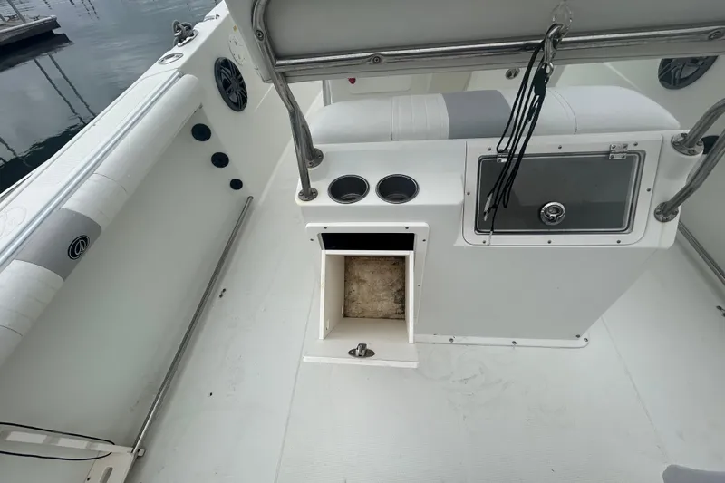 Slide: The Image of 2006 Sailfish 2660 CC boat interior with storage compartment and seating area. - 29
