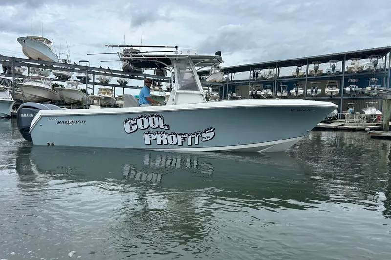 Slide: The Image of 2006 Sailfish 2660 CC boat named "Cool Profits" docked at a marina. - 4
