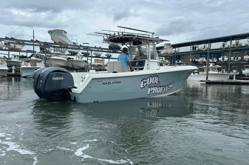 Slide: The Image of 2006 Sailfish 2660 CC boat with Yamaha engines, docked in a marina. - 5