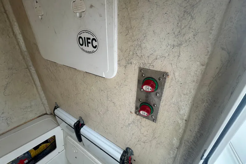 Slide: The Image of Interior of a 2006 Sailfish 2660 CC boat showing control panel and storage compartment. - 8