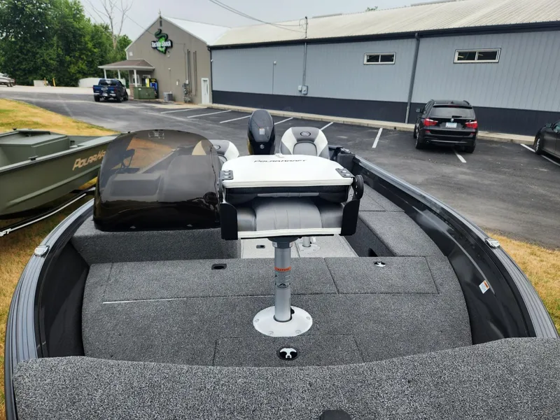 Slide: The Image of 2024 Polar Kraft Frontier 165 SCJ boat with seating, parked in a lot. - 11