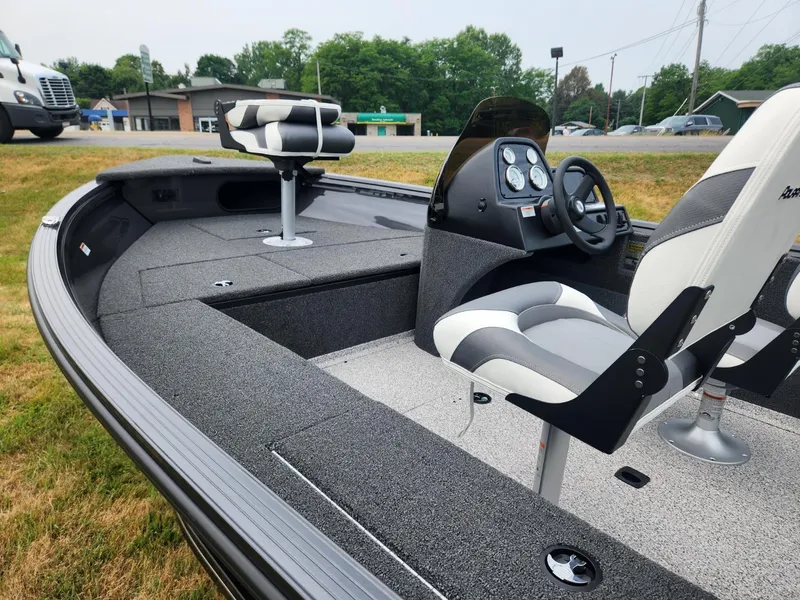 Slide: The Image of 2024 Polar Kraft Frontier 165 SCJ boat interior with seating and steering console. - 13