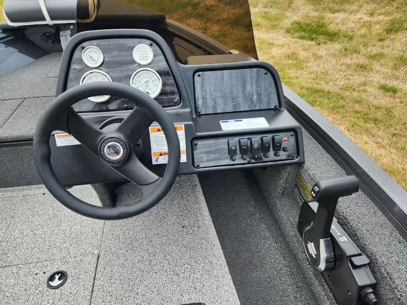 Slide: The Image of 2024 Polar Kraft Frontier 165 SCJ boat dashboard with steering wheel and control panel. - 14