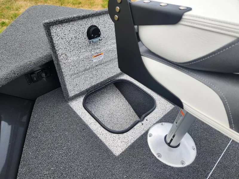 Slide: The Image of 2024 Polar Kraft Frontier 165 SCJ boat interior with storage compartment and swivel seat. - 15