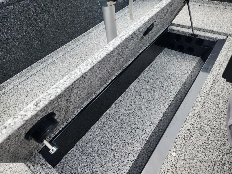 Slide: The Image of 2024 Polar Kraft Frontier 165 SCJ boat storage compartment open, showcasing interior space. - 17