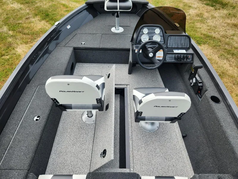 Slide: The Image of 2024 Polar Kraft Frontier 165 SCJ boat interior with dual seats and steering console. - 18