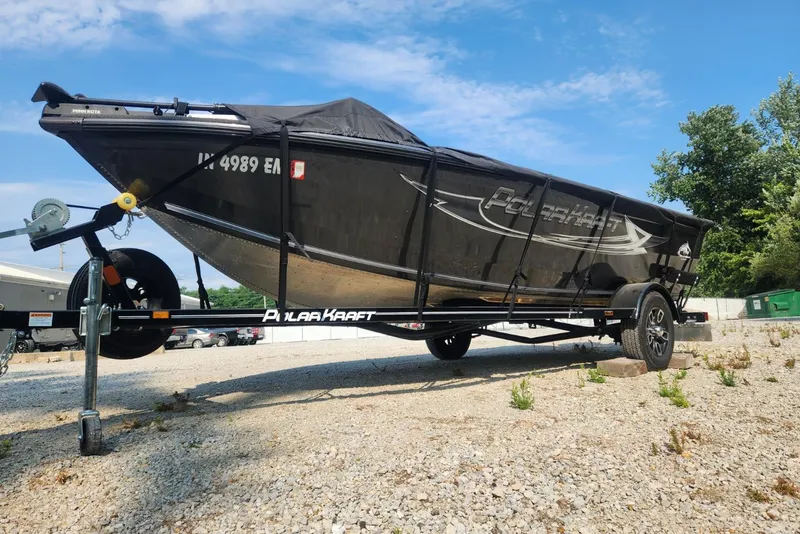 Slide: The Image of 2024 Polar Kraft Frontier 165 SCJ boat on trailer, covered, outdoors. - 21