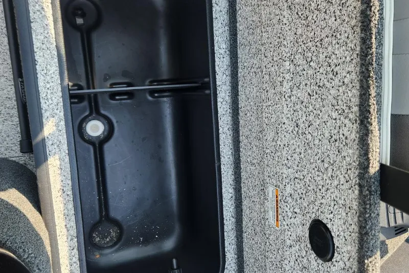 Slide: The Image of 2024 Polar Kraft Frontier 165 SCJ boat storage compartment with textured interior. - 25