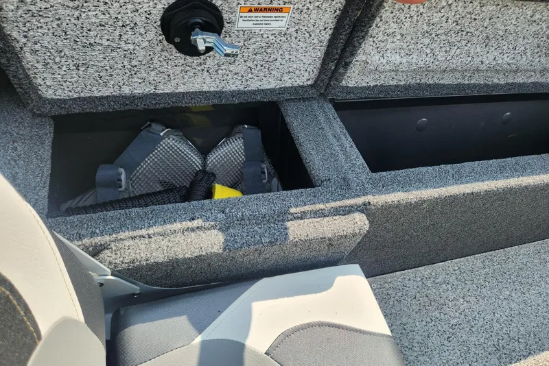 Slide: The Image of 2024 Polar Kraft Frontier 165 SCJ boat storage compartment with safety gear. - 28