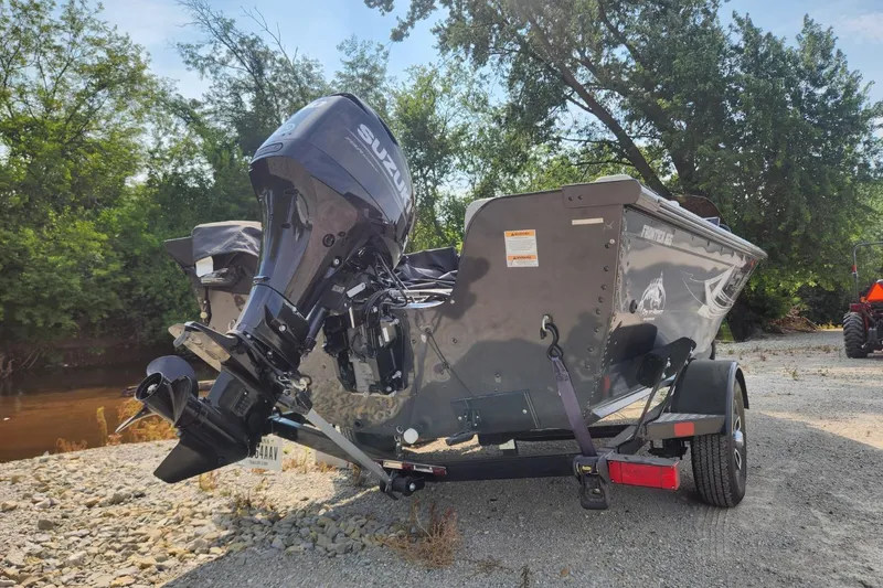 Slide: The Image of 2024 Polar Kraft Frontier 165 SCJ boat with Suzuki outboard motor on trailer. - 3
