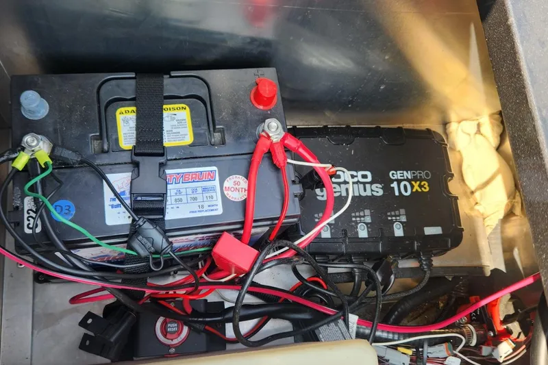 Slide: The Image of Battery and charger setup in a 2024 Polar Kraft Frontier 165 SCJ boat. - 30